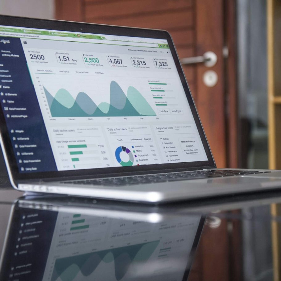 An image of a laptop screen showing financial graphs